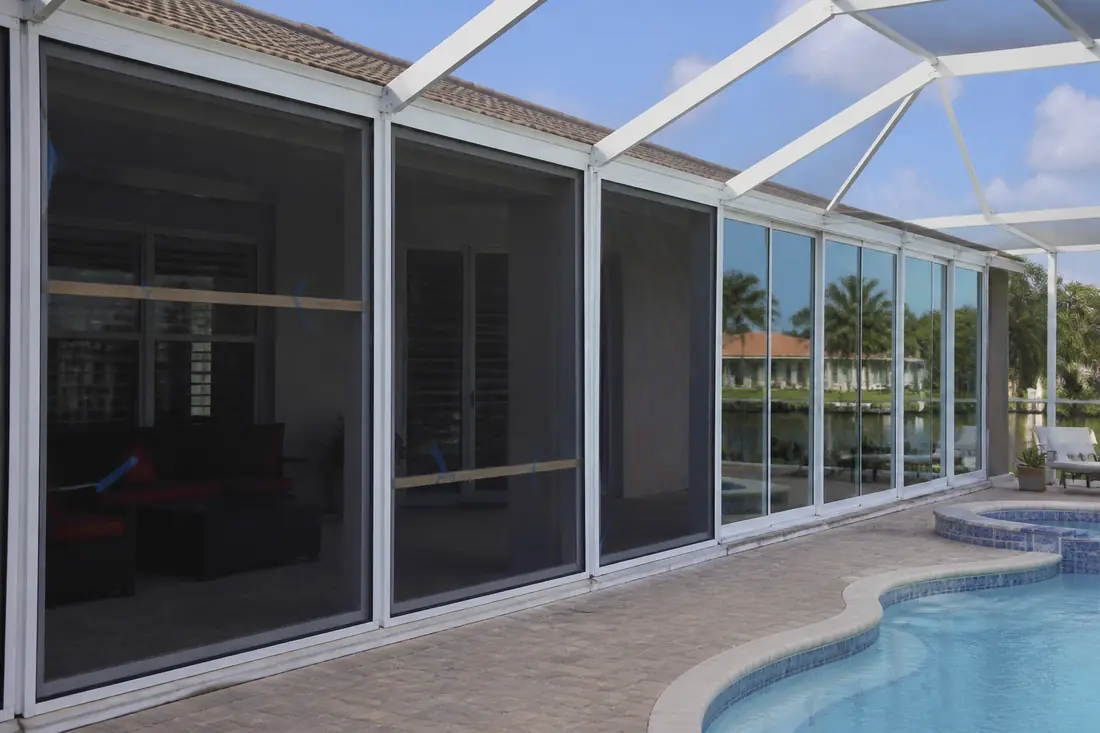 A lanai part-way through conversion, mesh panels in the near bays and glass in the far bays